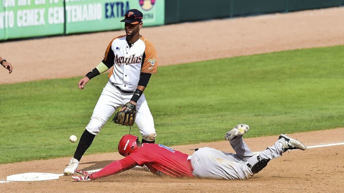 Henry Ramos (R) of Criollos de Caguas of Puerto Rico slides safe in third base during the Caribbean Baseball Series match against Aguilas del Zulia of Venezuela at the Tomateros stadium in Culiacan, Sinaloa State, Mexico, on February 6, 2017. / AFP / RONALDO SCHEMIDT (Photo credit should read RONALDO SCHEMIDT/AFP via Getty Images) Henry Ramos (R) of Criollos de Caguas of Puerto Rico slides safe in third base during the Caribbean Baseball Series match against Aguilas del Zulia of Venezuela at the Tomateros stadium in Culiacan, Sinaloa State, Mexico, on February 6, 2017. / AFP / RONALDO SCHEMIDT (Photo credit should read RONALDO SCHEMIDT/AFP via Getty Images)