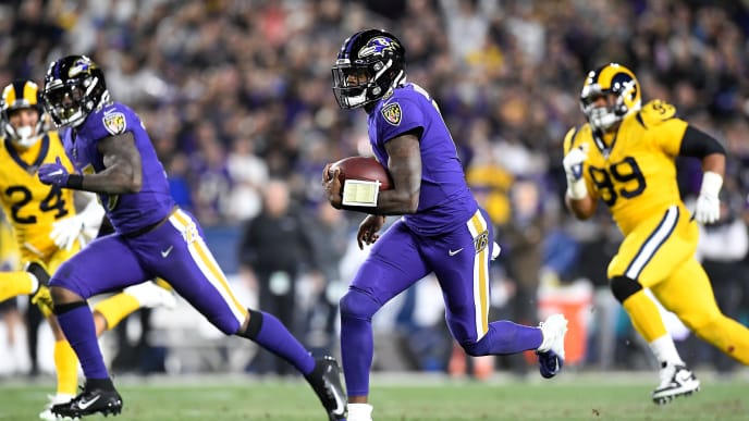 LOS ANGELES, CALIFORNIA - NOVEMBER 25: Quarterback Lamar Jackson #8 of the Baltimore Ravens carries the ball against the defense of the Los Angeles Rams at Los Angeles Memorial Coliseum on November 25, 2019 in Los Angeles, California. (Photo by Kevork Djansezian/Getty Images) LOS ANGELES, CALIFORNIA - NOVEMBER 25: Quarterback Lamar Jackson #8 of the Baltimore Ravens carries the ball against the defense of the Los Angeles Rams at Los Angeles Memorial Coliseum on November 25, 2019 in Los Angeles, California. (Photo by Kevork Djansezian/Getty Images)