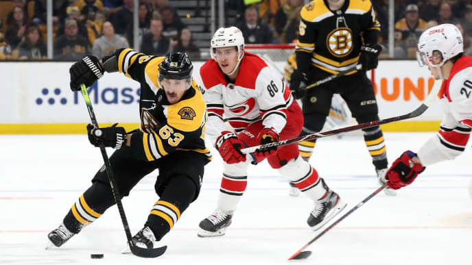 BOSTON, MASSACHUSETTS - MAY 12: Brad Marchand #63 of the Boston Bruins handles the puck against Sebastian Aho #20 of the Carolina Hurricanes during the first period in Game Two of the Eastern Conference Final during the 2019 NHL Stanley Cup Playoffs at TD Garden on May 12, 2019 in Boston, Massachusetts. (Photo by Bruce Bennett/Getty Images) BOSTON, MASSACHUSETTS - MAY 12: Brad Marchand #63 of the Boston Bruins handles the puck against Sebastian Aho #20 of the Carolina Hurricanes during the first period in Game Two of the Eastern Conference Final during the 2019 NHL Stanley Cup Playoffs at TD Garden on May 12, 2019 in Boston, Massachusetts. (Photo by Bruce Bennett/Getty Images)
