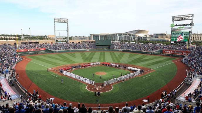 OMAHA, NEBRASKA - JUNE 13: A general view as the players from each of the 8 College World Series teams line up with the Detroit Tigers and the Kansas City Royals during the National Anthem ahead of the game at TD America Park on June 13, 2019 in Omaha, Nebraska. (Photo by Jamie Squire/Getty Images) OMAHA, NEBRASKA - JUNE 13: A general view as the players from each of the 8 College World Series teams line up with the Detroit Tigers and the Kansas City Royals during the National Anthem ahead of the game at TD America Park on June 13, 2019 in Omaha, Nebraska. (Photo by Jamie Squire/Getty Images)