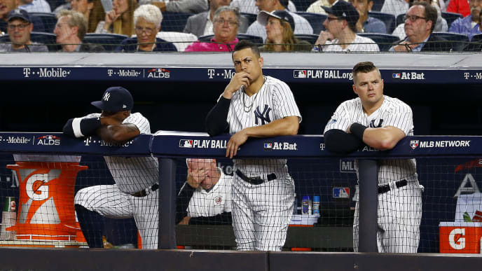 NEW YORK, NEW YORK - OCTOBER 09: Andrew McCutchen #26, Giancarlo Stanton #27 and Luke Voit #45 of the New York Yankees looks on from the dugout against the Boston Red Sox in Game Four of the American League Division Series at Yankee Stadium on October 09, 2018 in the Bronx borough of New York City. (Photo by Mike Stobe/Getty Images) NEW YORK, NEW YORK - OCTOBER 09: Andrew McCutchen #26, Giancarlo Stanton #27 and Luke Voit #45 of the New York Yankees looks on from the dugout against the Boston Red Sox in Game Four of the American League Division Series at Yankee Stadium on October 09, 2018 in the Bronx borough of New York City. (Photo by Mike Stobe/Getty Images)