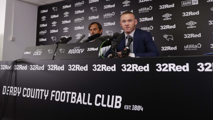 DC United midfielder and former England captain Wayne Rooney (R), alongside Derby County's Dutch manager Phillip Cocu, speaks during a press conference at Pride Park Stadium in Derby on August 6, 2019 after Rooney agreed a deal to become a player-coach. - Former England captain Wayne Rooney is to leave Washington-based DC United after agreeing a deal to become player-coach of English Championship side Derby County. The 33-year-old -- the record goalscorer for both his country and Manchester United -- signed an 18-month contract with the second-tier side, who under Rooney's former England teammate Frank Lampard reached the play-off final last season. (Photo by DARREN STAPLES / AFP) (Photo credit should read DARREN STAPLES/AFP/Getty Images) DC United midfielder and former England captain Wayne Rooney (R), alongside Derby County's Dutch manager Phillip Cocu, speaks during a press conference at Pride Park Stadium in Derby on August 6, 2019 after Rooney agreed a deal to become a player-coach. - Former England captain Wayne Rooney is to leave Washington-based DC United after agreeing a deal to become player-coach of English Championship side Derby County. The 33-year-old -- the record goalscorer for both his country and Manchester United -- signed an 18-month contract with the second-tier side, who under Rooney's former England teammate Frank Lampard reached the play-off final last season. (Photo by DARREN STAPLES / AFP) (Photo credit should read DARREN STAPLES/AFP/Getty Images)