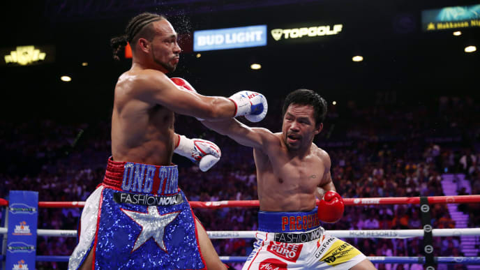 LAS VEGAS, NEVADA - JULY 20: Manny Pacquiao (R) connects with a punch on Keith Thurman during their WBA welterweight title fight at MGM Grand Garden Arena on July 20, 2019 in Las Vegas, Nevada. (Photo by Steve Marcus/Getty Images) LAS VEGAS, NEVADA - JULY 20: Manny Pacquiao (R) connects with a punch on Keith Thurman during their WBA welterweight title fight at MGM Grand Garden Arena on July 20, 2019 in Las Vegas, Nevada. (Photo by Steve Marcus/Getty Images)