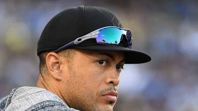 LOS ANGELES, CA - AUGUST 25: Giancarlo Stanton #27 of the New York Yankees looks on from the dugout during the game against the Los Angeles Dodgers at Dodger Stadium on August 25, 2019 in Los Angeles, California. Teams are wearing special color schemed uniforms with players choosing nicknames to display for Players' Weekend. (Photo by Jayne Kamin-Oncea/Getty Images) LOS ANGELES, CA - AUGUST 25: Giancarlo Stanton #27 of the New York Yankees looks on from the dugout during the game against the Los Angeles Dodgers at Dodger Stadium on August 25, 2019 in Los Angeles, California. Teams are wearing special color schemed uniforms with players choosing nicknames to display for Players' Weekend. (Photo by Jayne Kamin-Oncea/Getty Images)