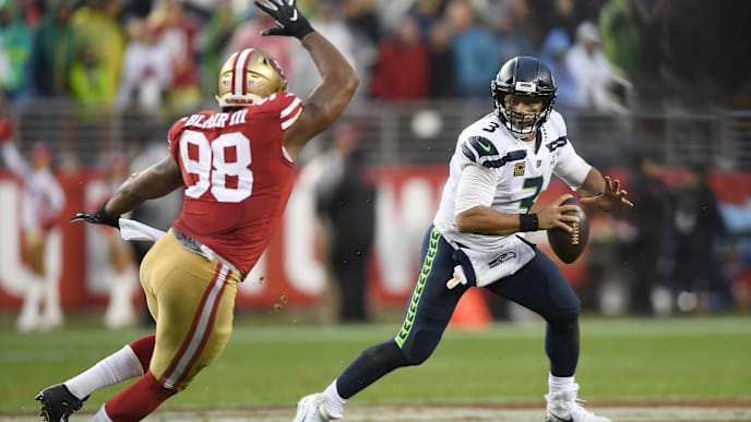SANTA CLARA, CA - DECEMBER 16: Russell Wilson #3 of the Seattle Seahawks rools out to pass pursued by Ronald Blair #98 of the San Francisco 49ers during an NFL football game at Levi's Stadium on December 16, 2018 in Santa Clara, California. (Photo by Thearon W. Henderson/Getty Images) SANTA CLARA, CA - DECEMBER 16: Russell Wilson #3 of the Seattle Seahawks rools out to pass pursued by Ronald Blair #98 of the San Francisco 49ers during an NFL football game at Levi's Stadium on December 16, 2018 in Santa Clara, California. (Photo by Thearon W. Henderson/Getty Images)