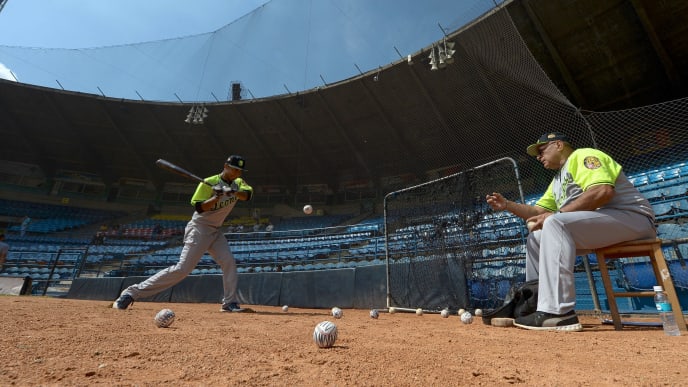Players of the Venezuelan baseball team Leones del Caracas attend a training session at the Universitario stadium in Caracas, on September 18, 2017.
While baseball is Venezuela's national sport, some fans are angry that the government, given the severity of the economic crisis and the political tension, will spend nearly ten million dollars on organizing the upcoming Winter League rather than on imports of food and medicine. / AFP PHOTO / FEDERICO PARRA (Photo credit should read FEDERICO PARRA/AFP/Getty Images) Players of the Venezuelan baseball team Leones del Caracas attend a training session at the Universitario stadium in Caracas, on September 18, 2017.
While baseball is Venezuela's national sport, some fans are angry that the government, given the severity of the economic crisis and the political tension, will spend nearly ten million dollars on organizing the upcoming Winter League rather than on imports of food and medicine. / AFP PHOTO / FEDERICO PARRA (Photo credit should read FEDERICO PARRA/AFP/Getty Images)