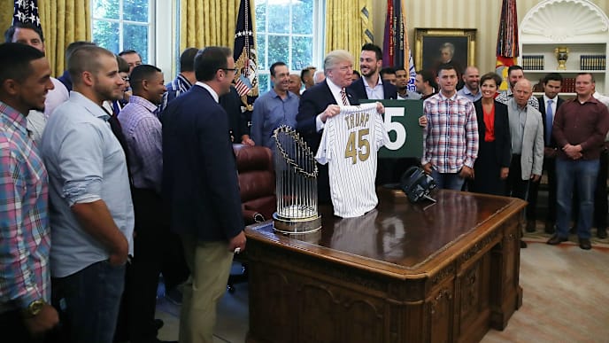 WASHINGTON, DC - JUNE 28: U.S. President Donald Trump is presented with a personalized baseball jersey during an event in the Oval Office to honor the 2016 World Series Champion Chicago Cubs at the White House, on June 28, 2017 in Washington, DC. The Cubs beat the Cleveland Indians in last year's World Series ending the team's 108-year championship drought. (Photo by Mark Wilson/Getty Images) WASHINGTON, DC - JUNE 28: U.S. President Donald Trump is presented with a personalized baseball jersey during an event in the Oval Office to honor the 2016 World Series Champion Chicago Cubs at the White House, on June 28, 2017 in Washington, DC. The Cubs beat the Cleveland Indians in last year's World Series ending the team's 108-year championship drought. (Photo by Mark Wilson/Getty Images)