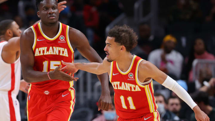 ATLANTA, GEORGIA - DECEMBER 13: Clint Capela #15 of the Atlanta Hawks reacts after dunking alley-oop pass from Trae Young #11 against the Houston Rockets during the first half at State Farm Arena on December 13, 2021 in Atlanta, Georgia. NOTE TO USER: User expressly acknowledges and agrees that, by downloading and or using this photograph, User is consenting to the terms and conditions of the Getty Images License Agreement. (Photo by Kevin C. Cox/Getty Images)