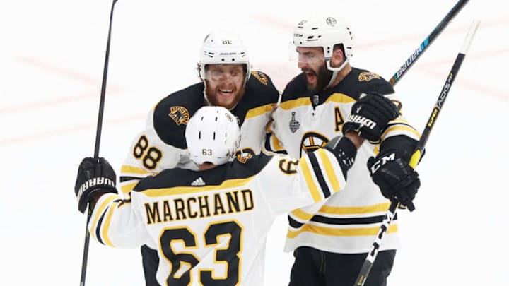 ST LOUIS, MISSOURI - JUNE 01: Patrice Bergeron #37 of the Boston Bruins is congratulated by his teammates David Pastrnak #88 and Brad Marchand #63 after scoring a first period goal against the St. Louis Blues in Game Three of the 2019 NHL Stanley Cup Final at Enterprise Center on June 01, 2019 in St Louis, Missouri. (Photo by Jamie Squire/Getty Images)