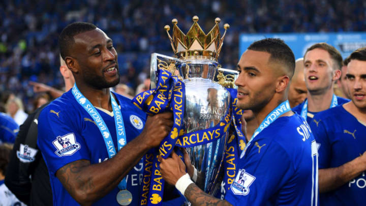 LEICESTER, ENGLAND – MAY 07: Wes Morgan and Danny Simpson of Leicester City pose for photographs with the Premier League Trophy as players and staffs celebrate the season champions after the Barclays Premier League match between Leicester City and Everton at The King Power Stadium on May 7, 2016 in Leicester, United Kingdom. (Photo by Shaun Botterill/Getty Images)