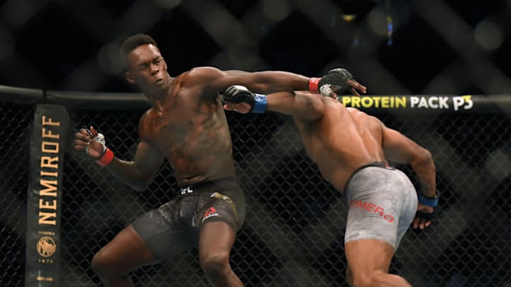 LAS VEGAS, NEVADA - MARCH 07: Israel Adesanya reacts to a punch from Yoel Romero in a Adesanya decision win to retain the middleweight title at T-Mobile Arena on March 07, 2020 in Las Vegas, Nevada. (Photo by Harry How/Getty Images)