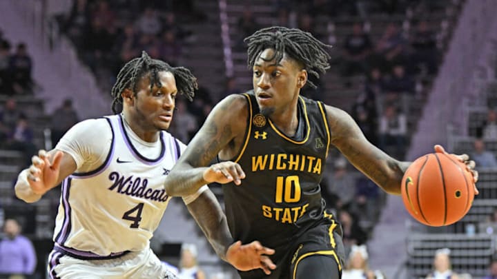 MANHATTAN, KS - DECEMBER 03: Jaykwon Walton #10 of the Wichita State Shockers drives with the ball in the first half against Tykei Greene #4 of the Kansas State Wildcats at Bramlage Coliseum on December 3, 2022 in Manhattan, Kansas. (Photo by Peter G. Aiken/Getty Images)