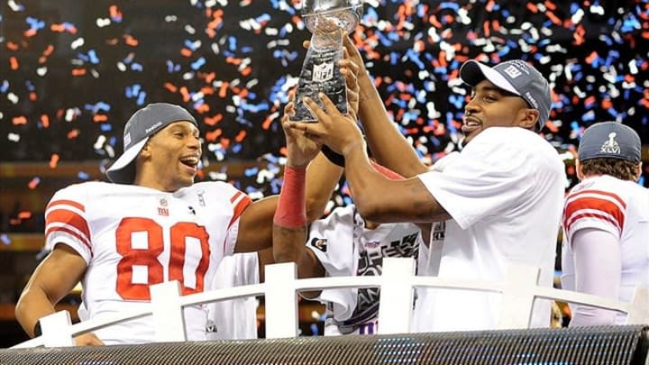 Feb 5, 2012; Indianapolis, IN, USA; New York Giants wide receiver Victor Cruz (80) and wide receiver Hakeem Nicks (right) celebrate with the Vince Lombardi Trophy after the Giants defeated the New England Patriots 21-17 in Super Bowl XLVI at Lucas Oil Stadium. Mandatory Credit: Mark J. Rebilas-USA TODAY Sports