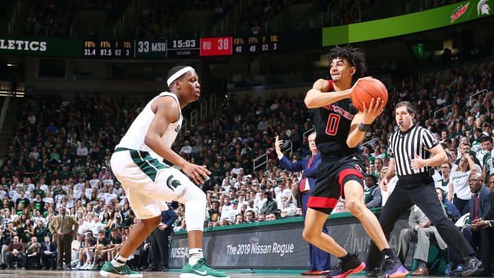 EAST LANSING, MI – FEBRUARY 20: Geo Baker #0 of the Rutgers Scarlet Knights looks to pass the ball while defended by Cassius Winston #5 of the Michigan State Spartans in the second half at Breslin Center on February 20, 2019 in East Lansing, Michigan. (Photo by Rey Del Rio/Getty Images)