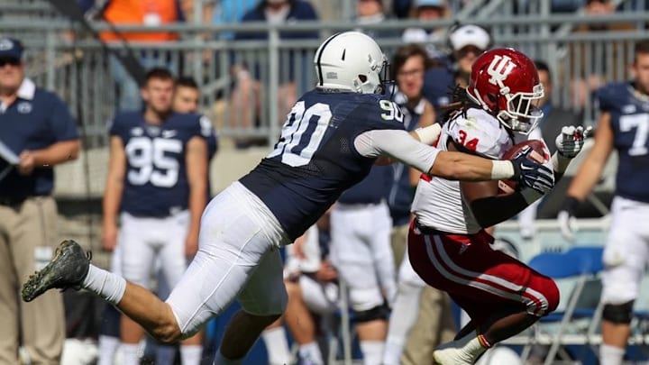 Oct 10, 2015; University Park, PA, USA; Indiana Hoosiers running back Devine Redding (34) with the ball as Penn State Nittany Lions defensive end Garrett Sickels (90) attempts a tackle during the second quarter at Beaver Stadium. Penn State defeated Indiana 29-7. Mandatory Credit: Matthew O