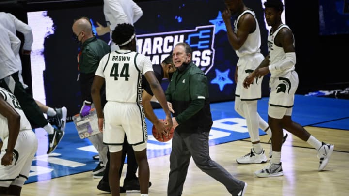 Mar 18, 2021; West Lafayette, Indiana, USA; Michigan State Spartans head coach Tom Izzo heads into the locker room as he talks with forward Gabe Brown (44) at half time during the First Four of the 2021 NCAA Tournament at Mackey Arena. Mandatory Credit: Marc Lebryk-USA TODAY Sports