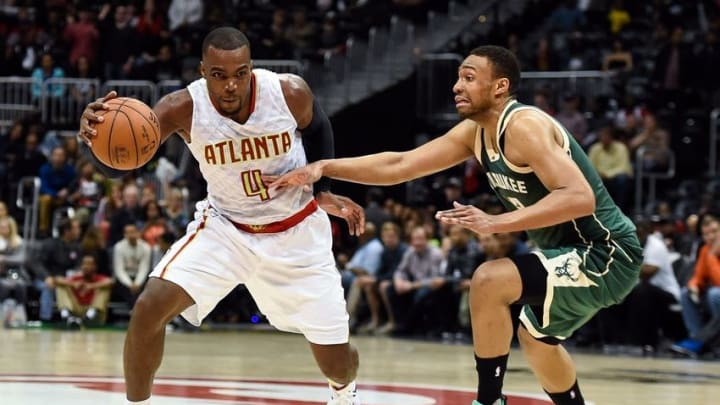 Feb 20, 2016; Atlanta, GA, USA; Atlanta Hawks forward Paul Millsap (4) is defended by Milwaukee Bucks forward Jabari Parker (12) during the second half at Philips Arena. The Bucks defeated the Hawks 117-109 in double overtime. Mandatory Credit: Dale Zanine-USA TODAY Sports