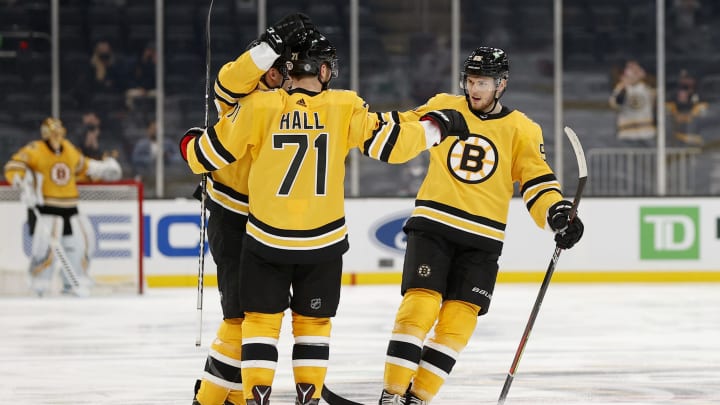 BOSTON, MASSACHUSETTS – APRIL 15: Taylor Hall #71 of the Boston Bruins celebrates with Jeremy Lauzon #55 and Patrice Bergeron #37 after scoring a goal against the New York Islanders during the third period at TD Garden on April 15, 2021 in Boston, Massachusetts. The Bruins defeat the Islanders 4-1. (Photo by Maddie Meyer/Getty Images)