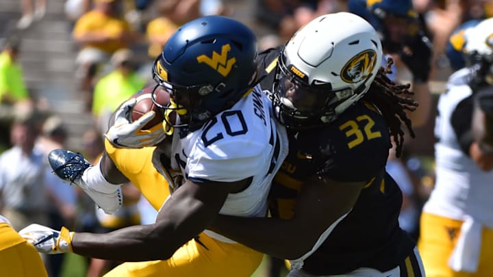 COLUMBIA, MISSOURI – SEPTEMBER 07: Running back Alec Sinkfield #20 of the West Virginia Mountaineers is tackled by linebacker Nick Bolton #32 of the Missouri Tigers in the fourth quarter at Faurot Field/Memorial Stadium on September 07, 2019 in Columbia, Missouri. (Photo by Ed Zurga/Getty Images)