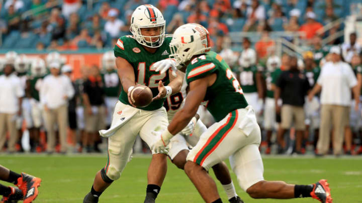 MIAMI GARDENS, FL - NOVEMBER 18: Malik Rosier #12 hands off to Travis Homer #24 of the Miami Hurricanes during a game against the Virginia Cavaliers at Hard Rock Stadium on November 18, 2017 in Miami Gardens, Florida. (Photo by Mike Ehrmann/Getty Images)