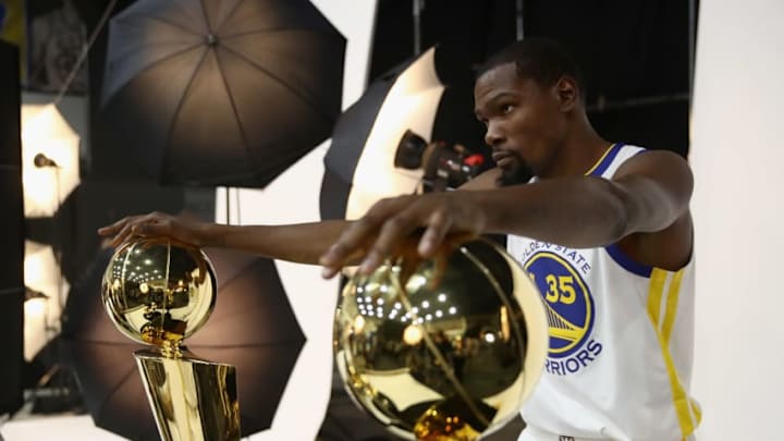 OAKLAND, CA - SEPTEMBER 24: Kevin Durant #35 of the Golden State Warriors poses with two Larry O'Brien NBA Championship Trophies and two NBA Finals MVP trophies during the Golden State Warriors media day on September 24, 2018 in Oakland, California. (Photo by Ezra Shaw/Getty Images)