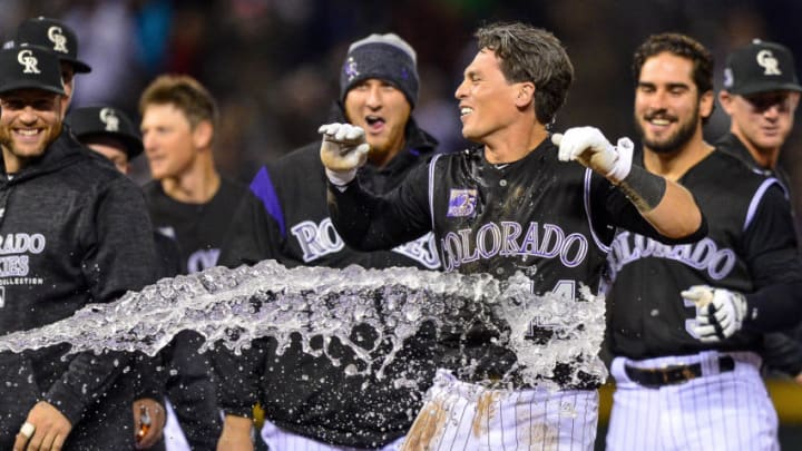 DENVER, CO - APRIL 7: Tony Wolters #14 of the Colorado Rockies celebrates and is doused with water after earning a base on balls with the bases loaded for a walk off RBI walk against the Atlanta Braves at Coors Field on April 7, 2018 in Denver, Colorado. (Photo by Dustin Bradford/Getty Images)