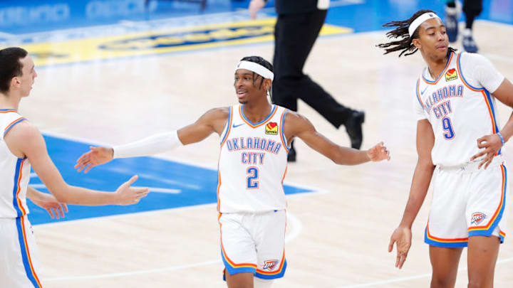 Mar 14, 2021; Oklahoma City, Oklahoma, USA; Oklahoma City Thunder guard Shai Gilgeous-Alexander (2) celebrates with forward Aleksej Pokusevski (L) and center Moses Brown (9) during the second half against the Memphis Grizzlies at Chesapeake Energy Arena. Mandatory Credit: Alonzo Adams-USA TODAY Sports