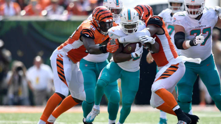 CINCINNATI, OH - OCTOBER 7: Preston Brown #52 of the Cincinnati Bengals and Carlos Dunlap #96 combine to tackle Kenyan Drake #32 of the Miami Dolphins during the first quarter at Paul Brown Stadium on October 7, 2018 in Cincinnati, Ohio. (Photo by Bobby Ellis/Getty Images)