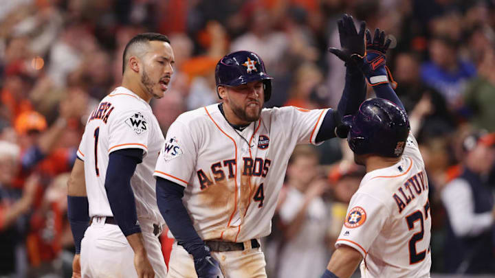MLB Daily Fantasy: HOUSTON, TX - OCTOBER 29: George Springer #4 of the Houston Astros celebratres with Carlos Correa #1 and Jose Altuve #27 after hitting a solo home run during the seventh inning against the Los Angeles Dodgers in game five of the 2017 World Series at Minute Maid Park on October 29, 2017 in Houston, Texas. (Photo by Christian Petersen/Getty Images)