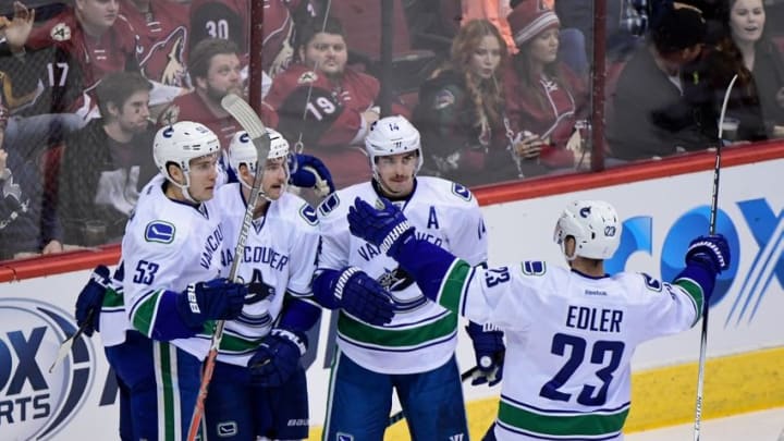 Nov 23, 2016; Glendale, AZ, USA; Vancouver Canucks left wing Sven Baertschi (47) celebrates with defenseman Alexander Edler (23) center Bo Horvat (53) and left wing Alex Burrows (14) after scoring a goal in the first period against the Arizona Coyotes at Gila River Arena. Mandatory Credit: Matt Kartozian-USA TODAY Sports