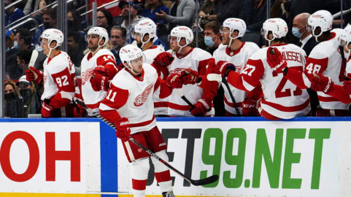 Oct 30, 2021; Toronto, Ontario, CAN; Detroit Red Wings right wing Filip Zadina (11) celebrates scoring a goal at the team bench during the second period against the Toronto Maple Leafs at Scotiabank Arena. Mandatory Credit: Nick Turchiaro-USA TODAY Sports