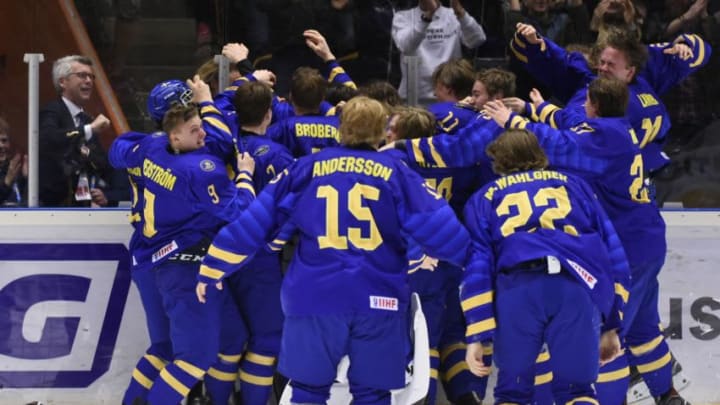 Sweden players celebrate their 4-3 win after a goal by Lucas Raymond (Photo by Erik MARTENSSON / TT News Agency / AFP) / Sweden OUT (Photo credit should read ERIK MARTENSSON/AFP via Getty Images)