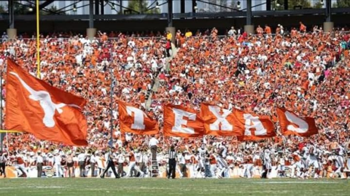 Oct 12, 2013; Dallas, TX, USA; Texas Longhorns cheerleaders carry the Texas flags on the field after a score against the Oklahoma Sooners during the Red River Rivalry at the Cotton Bowl Stadium. Mandatory Credit: Matthew Emmons-USA TODAY Sports