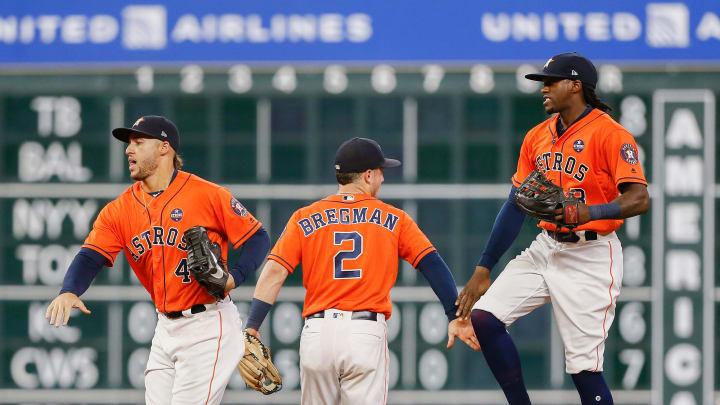 HOUSTON, TX – SEPTEMBER 22: Alex Bregman #2 of the Houston Astros and George Springer #4 and Cameron Maybin #3 celebrate a 3-0 win over the Los Angeles Angels of Anaheim at Minute Maid Park on September 22, 2017 in Houston, Texas. (Photo by Bob Levey/Getty Images)