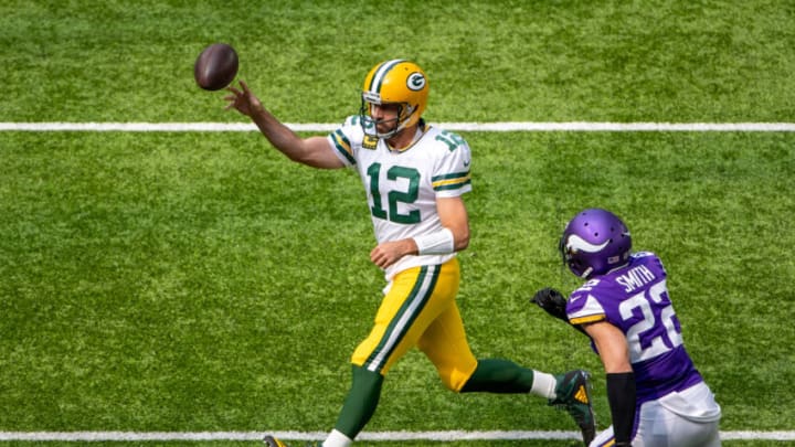 Sep 13, 2020; Minneapolis, Minnesota, USA Green Bay Packers quarterback Aaron Rodgers (12) drops back for a pass as Minnesota Vikings free safety Harrison Smith (22) rushes towards him in the first half at U.S. Bank Stadium. Mandatory Credit: Jesse Johnson-USA TODAY Sports