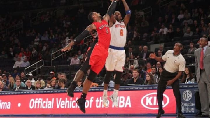 Oct 13, 2014; New York, NY, USA; New York Knicks shooting guard J.R. Smith (8) shoots past Toronto Raptors power forward James Johnson (3) during the fourth quarter at Madison Square Garden. Mandatory Credit: Brad Penner-USA TODAY Sports