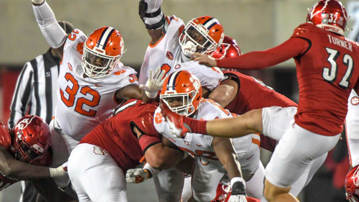 Clemson defensive tackle Etinosa Reuben (32) and defensive tackle Tyler Davis (13) reach out to attempt blocking a field goal by Louisville kicker James Turner (32) during the fourth quarter at Cardinal Stadium in Louisville, Kentucky Saturday, November 6, 2021.