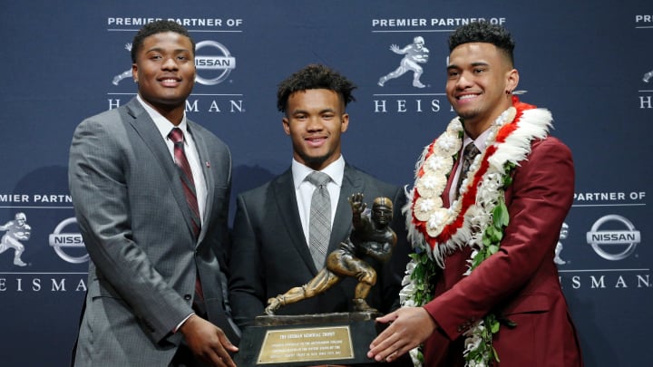 Dec 8, 2018; New York, NY, USA; Heisman Trophy finalists (left to right) Ohio State Buckeyes quarterback Dwayne Haskins and Oklahoma Sooners quarterback Kyler Murray and Alabama Crimson Tide quarterback Tua Tagovailoa pose with the Heisman Trophy during a press conference at the New York Marriott Marquis before the Heisman Trophy announcement ceremony. Mandatory Credit: Brad Penner-USA TODAY Sports