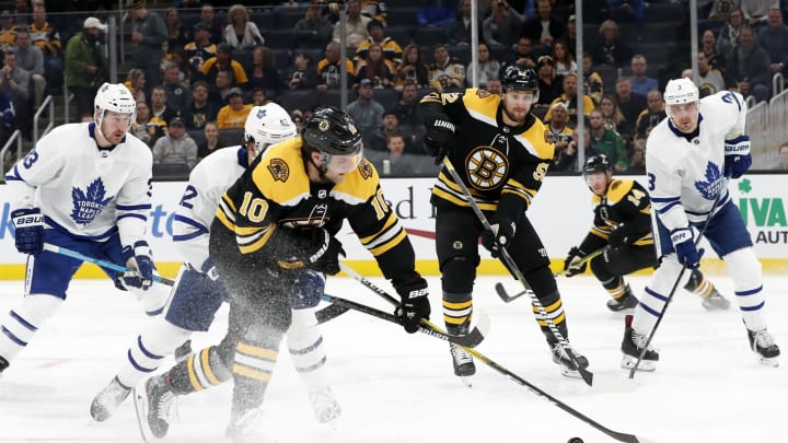 BOSTON, MA - OCTOBER 22: Boston Bruins right wing Anders Bjork (10) picks up a loose puck during a game between the Boston Bruins and the Toronto Maple Leafs on October 22, 2019, at TD Garden in Boston, Massachusetts. (Photo by Fred Kfoury III/Icon Sportswire via Getty Images)