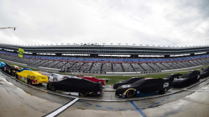 Nov 6, 2016; Fort Worth, TX, USA; A view of the covered cars during the rain delayed start of AAA Texas 500 at Texas Motor Speedway. Mandatory Credit: Jerome Miron-USA TODAY Sports