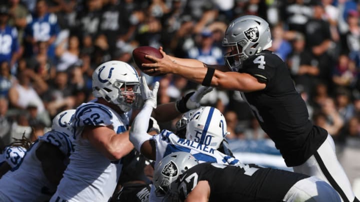 OAKLAND, CA - OCTOBER 28: Derek Carr #4 of the Oakland Raiders dives for a one-yard touchdown against the Indianapolis Colts during their NFL game at Oakland-Alameda County Coliseum on October 28, 2018 in Oakland, California. (Photo by Robert Reiners/Getty Images)
