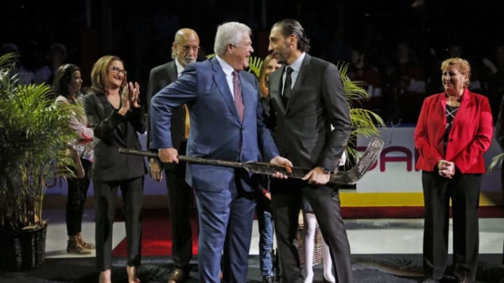 SUNRISE, FL - OCTOBER 13: Goaltender Roberto Luongo is presented with a gold and crystal stick by President of Hockey Operations and General Manager Dale Tallon during a celebration of playing in 1000th NHL game prior to the Florida Panthers hosting the Vancouver Canucks at the BB&T Center on October 13, 2018 in Sunrise, Florida. (Photo by Eliot J. Schechter/NHLI via Getty Images)