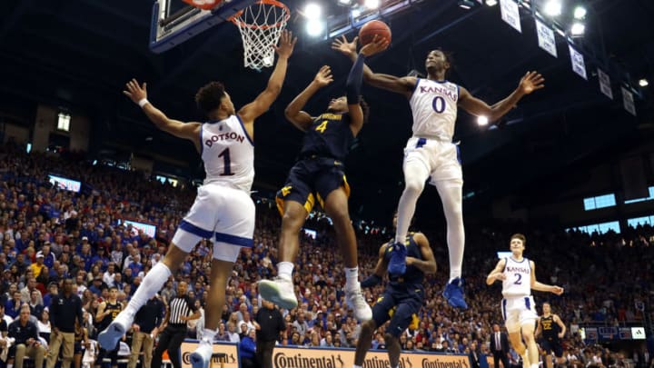 LAWRENCE, KANSAS - JANUARY 04: Marcus Garrett #0 of the Kansas Jayhawks swats the ball out of the hands of Miles McBride #4 of the West Virginia Mountaineers during the game at Allen Fieldhouse on January 04, 2020 in Lawrence, Kansas. (Photo by Jamie Squire/Getty Images)