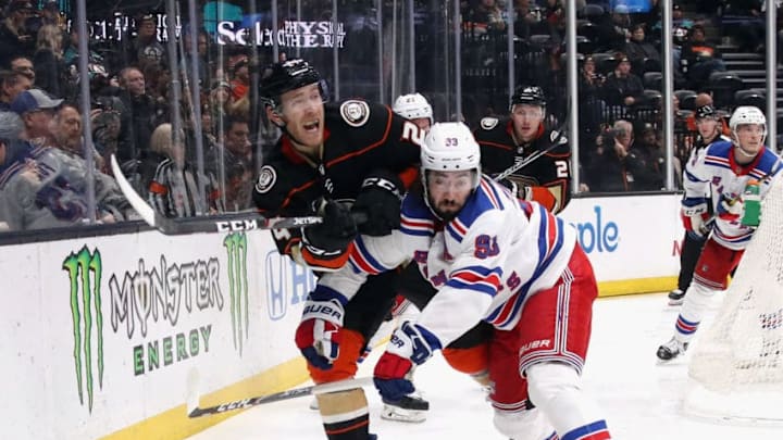 ANAHEIM, CALIFORNIA - DECEMBER 14: Carter Rowney #24 of the Anaheim Ducks skates against Mika Zibanejad #93 of the New York Rangers at the Honda Center on December 14, 2019 in Anaheim, California. (Photo by Bruce Bennett/Getty Images)