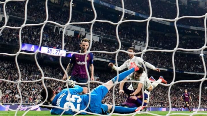 Barcelona's Croatian midfielder Ivan Rakitic (C) scores a goal during the Spanish league football match between Real Madrid CF and FC Barcelona at the Santiago Bernabeu stadium in Madrid on March 2, 2019. (Photo by JAVIER SORIANO / AFP) (Photo credit should read JAVIER SORIANO/AFP/Getty Images)