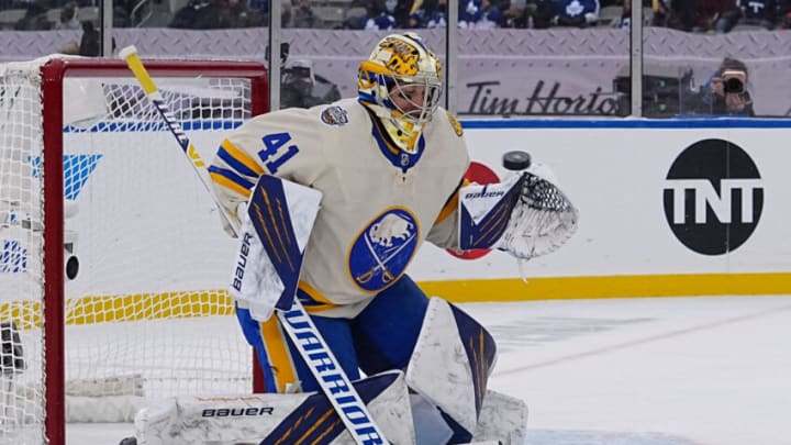 Mar 13, 2022; Hamilton, Ontario, CAN; Buffalo Sabres goaltender Craig Anderson (41) blocks a shot by the Toronto Maple Leafs during the second period in the 2022 Heritage Classic ice hockey game at Tim Hortons Field. Mandatory Credit: John E. Sokolowski-USA TODAY Sports