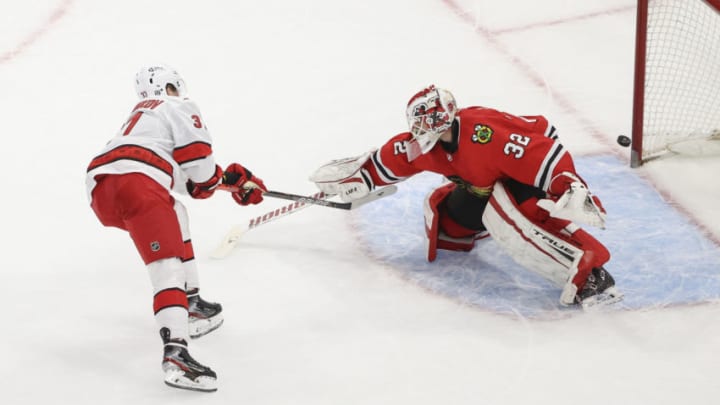 Feb 2, 2021; Chicago, Illinois, USA; Carolina Hurricanes right wing Andrei Svechnikov (37) scores a goal against Chicago Blackhawks goaltender Kevin Lankinen (32) during a shoot-out at United Center. Mandatory Credit: Kamil Krzaczynski-USA TODAY Sports