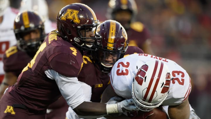 MINNEAPOLIS, MN – NOVEMBER 25: Adekunle Ayinde #4 and Jacob Huff #2 of the Minnesota Golden Gophers tackle Jonathan Taylor #23 of the Wisconsin Badgers during the third quarter of the game on November 25, 2017 at TCF Bank Stadium in Minneapolis, Minnesota. The Badgers defeated the Golden Gophers 31-0. (Photo by Hannah Foslien/Getty Images)