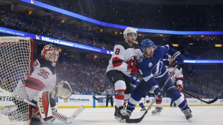 TAMPA, FL - APRIL 21: Tyler Johnson #9 of the Tampa Bay Lightning skates against Will Butcher #8 and Cory Schneider #35 of the New Jersey Devils in Game Five of the Eastern Conference First Round during the 2018 NHL Stanley Cup Playoffs at Amalie Arena on April 21, 2018 in Tampa, Florida. (Photo by Mark LoMoglio/NHLI via Getty Images)"n