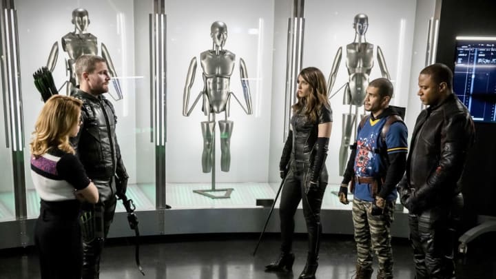 Arrow — “Inheritance” — Image Number: AR717b_0441b — Pictured (L-R): Emily Bett Rickards as Felicity Smoak, Stephen Amell as Oliver Queen/Green Arrow, Juliana Harkavy as Dinah Drake/Black Canary, Rick Gonzalez as Rene Ramirez/Wild Dog and David Ramsey as John Diggle/Spartan — Photo: Jack Rowand/The CW — Ã‚Â© 2019 The CW Network, LLC. All Rights Reserved.